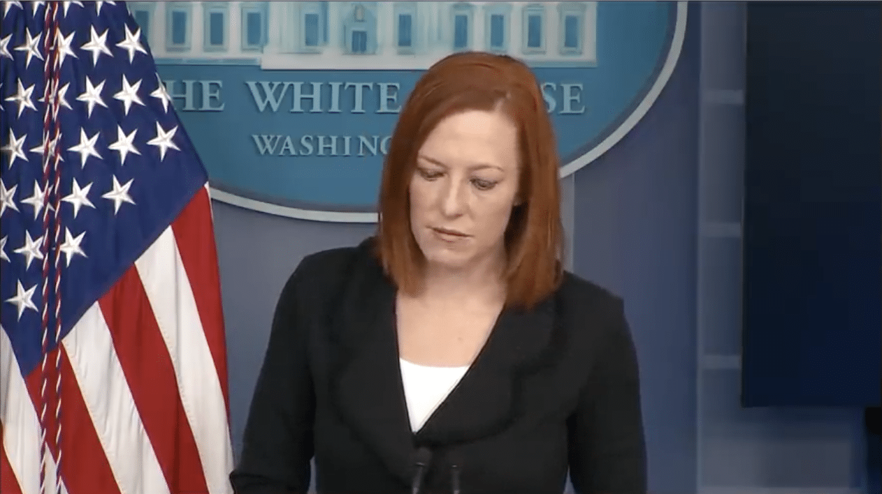 Former White House Press Secretary Jen Psaki looks downward at her notes.